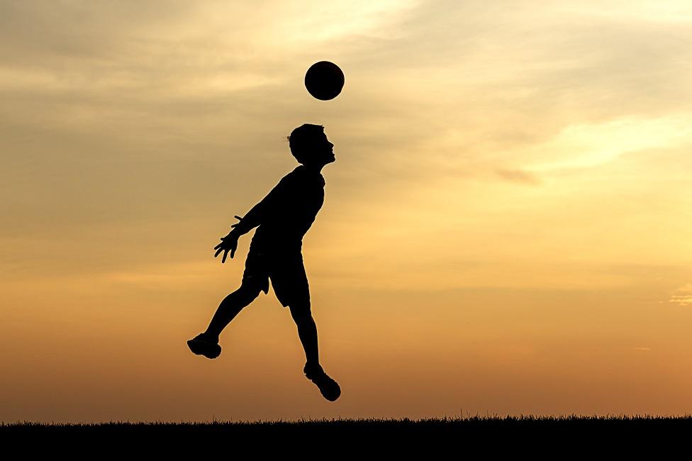 Child heading football