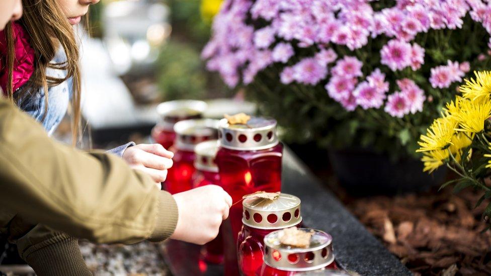 children lighting candles