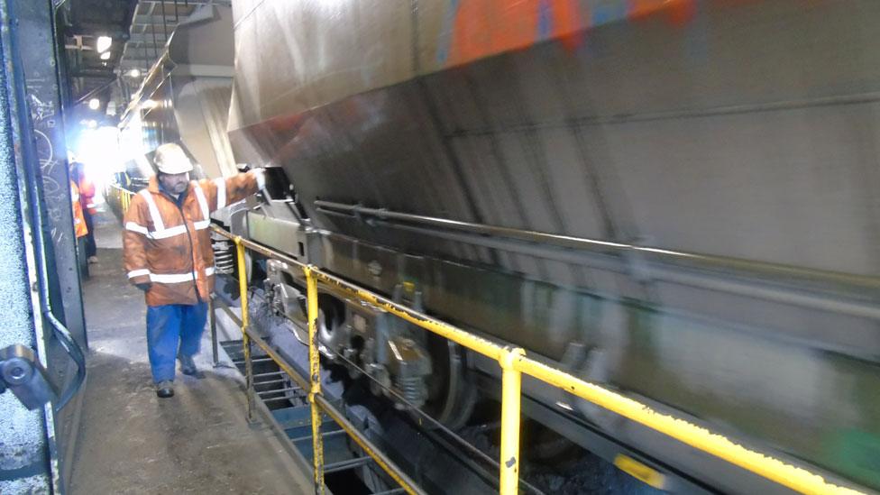 Coal is emptied from the bottom of the rail wagons onto a conveyor below