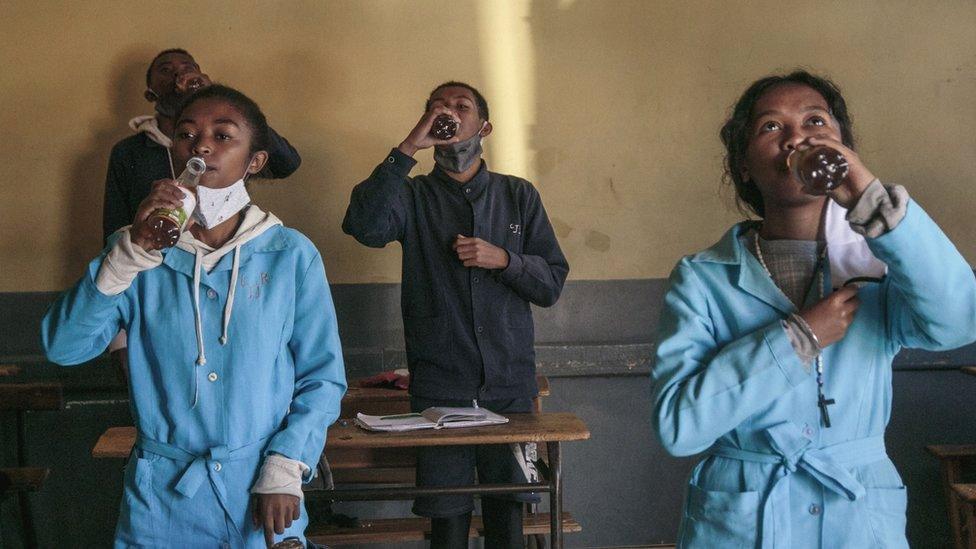 Students in Madagascar drinking the Covid-Organics herbal tonic - April 2020