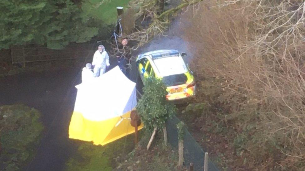 A police tent and officers from above