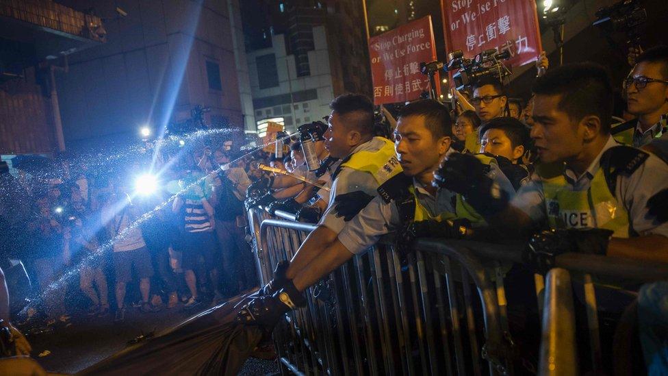 Police use pepper spray to stop protesters charging outside the Chinese Liason Office in Hong Kong on November 6, 2016, during a protest against an expected interpretation of the city"s constitution - the Basic Law - by China"s National People"s Congress Standing Committee