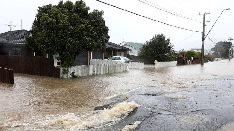 Flood water flows through cracks in the road surface after a bout of severe weather in Wellington (15 November 2016)