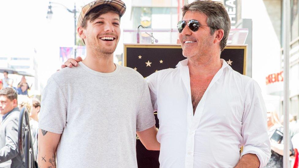 Louis Tomlinson and Simon Cowell laugh together