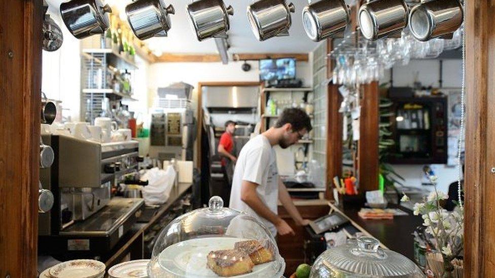 A picture shows the interior of the 'The Convenience', a former public toilet that has been converted into a coffee shop in Hackney, east London