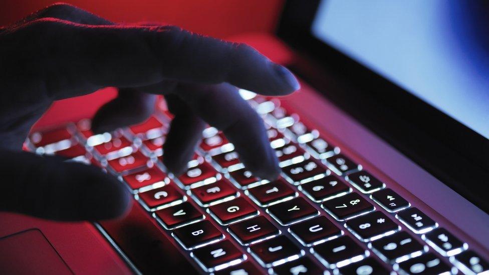 A man typing on a keyboard