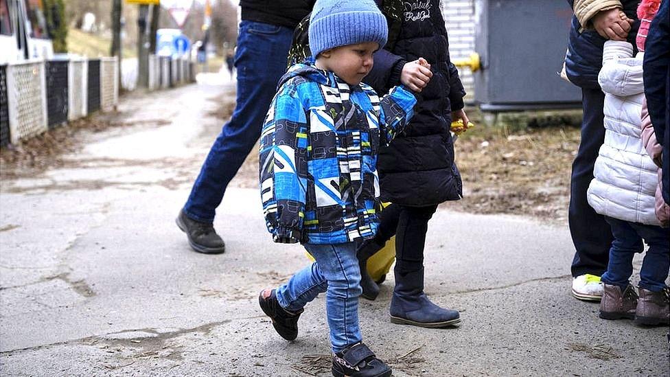 little boy led by the hand