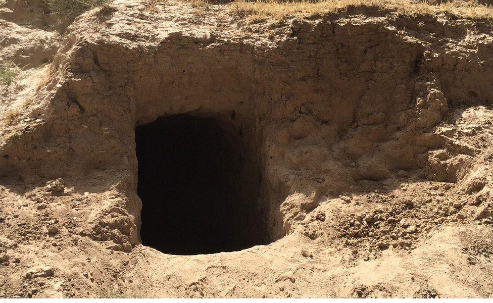 Entrance to tunnels dug by IS in hillside in Qayara