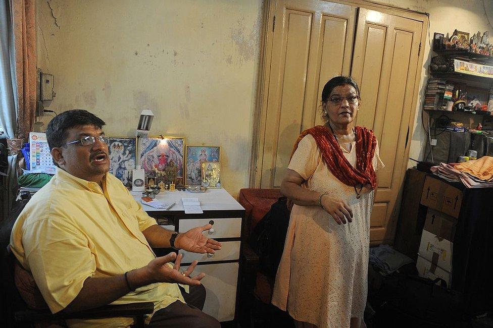 Prasad Panvalkar (L) and wife Smita are seen inside their apartment in the Pathare Prabhu building, due to be demolished to make way for a luxury apartment building, in Mumbai on June 24, 2011.