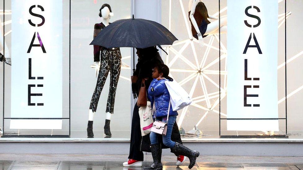 People walking past shop