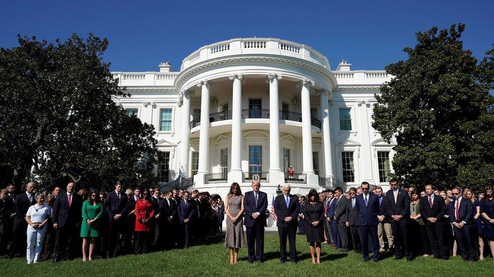 US President Donald Trump, First Lady Melania Trump, Vice-President Pence and his wife and White House staff stand for a minute's silence at the White House on 2 October 2017