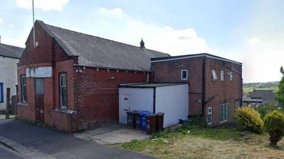 Street view image of the existing red brick building