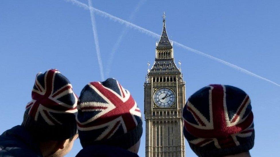 Men wearing Union Jack hats staring at the Elizabeth Clock Tower