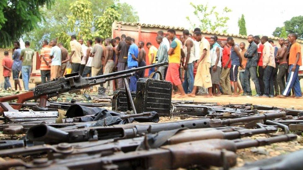 Suspected fighters are paraded before the media by Burundian police near a recovered cache of weapons after clashes in the capital Bujumbura, Burundi - 12 December 2015