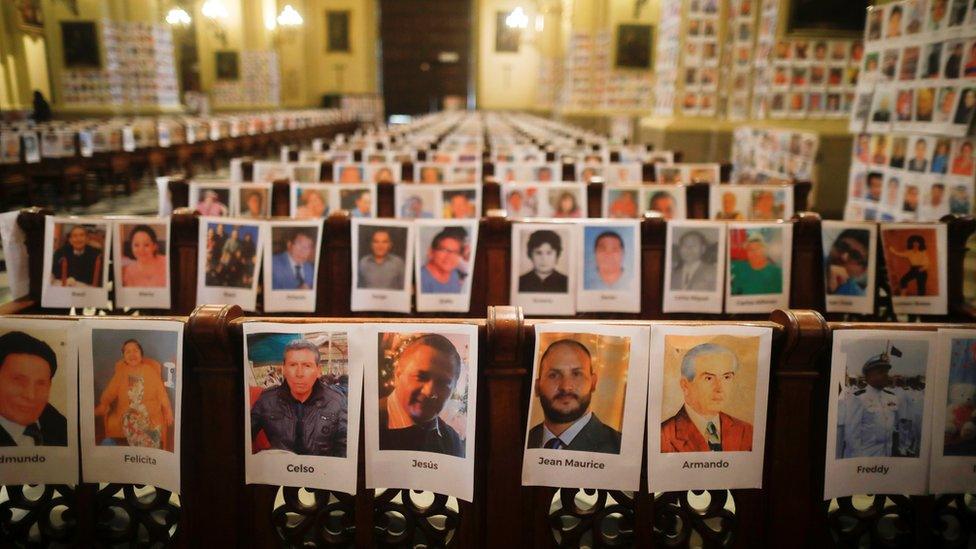 Photographs of Peru's victims of the coronavirus disease (COVID-19) are seen on the pews and walls of the Cathedral of Lima