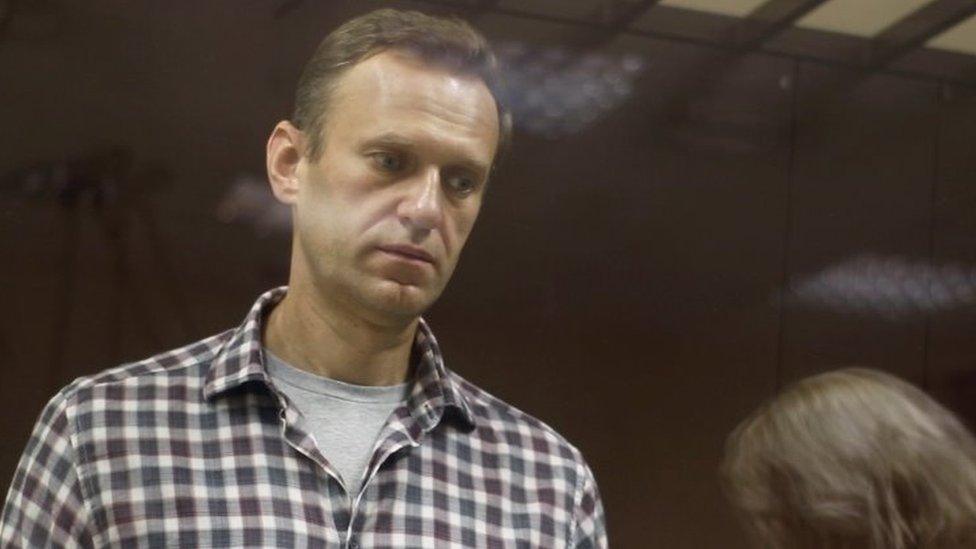 Kremlin critic Alexei Navalny stands inside a defendant dock during a court hearing in Moscow, Russia, on 20 February 2021,