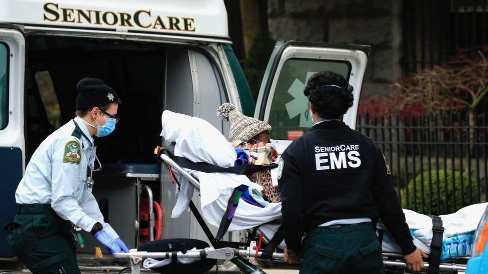 Ambulance staff with a patient at the Cobble Hill Health Center, Brooklyn, NY 18 April 2020