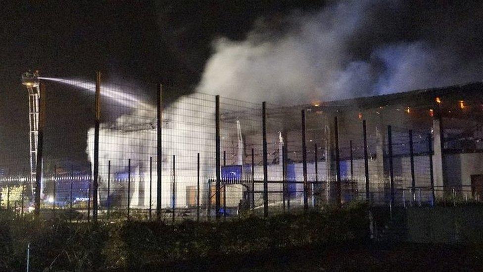 Firefighters try to extinguish a fire in the gym in Nauen, Germany, 25 August 2015