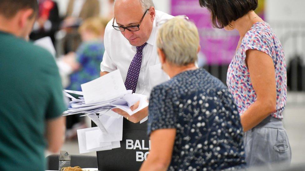 A person counting ballots