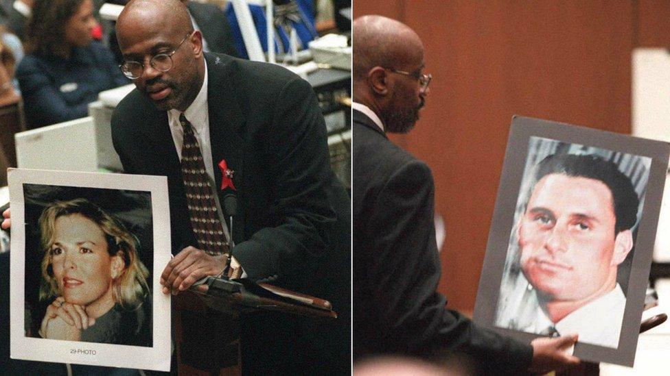 Prosecutor Christopher Darden holds up photographs of victims to jury at 1995 trial