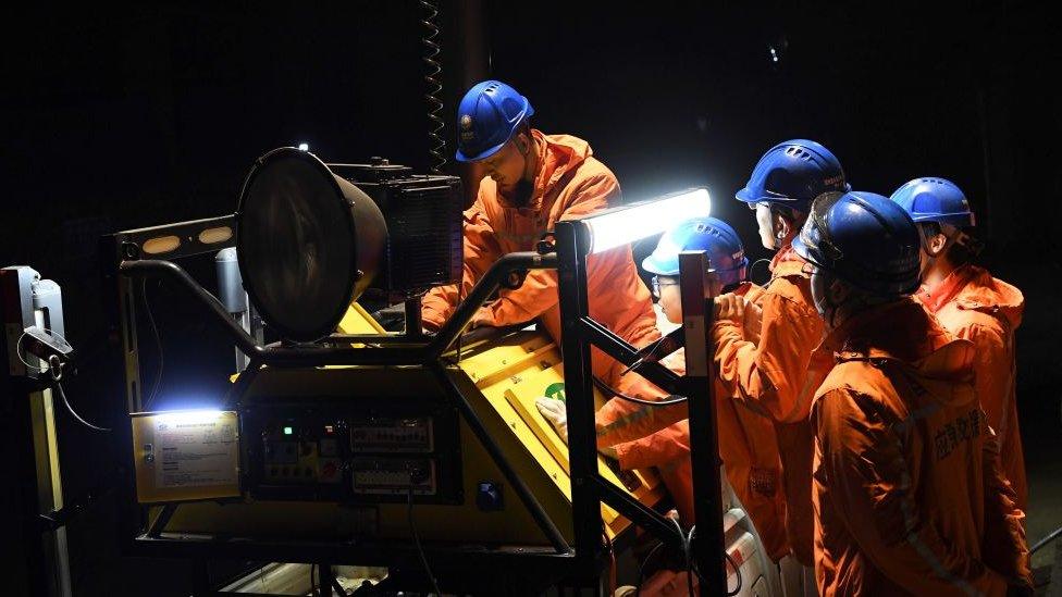 Rescuers adjust an emergency generator at the Diaoshuidong coal mine in south-western China's Chongqing on December 5, 2020