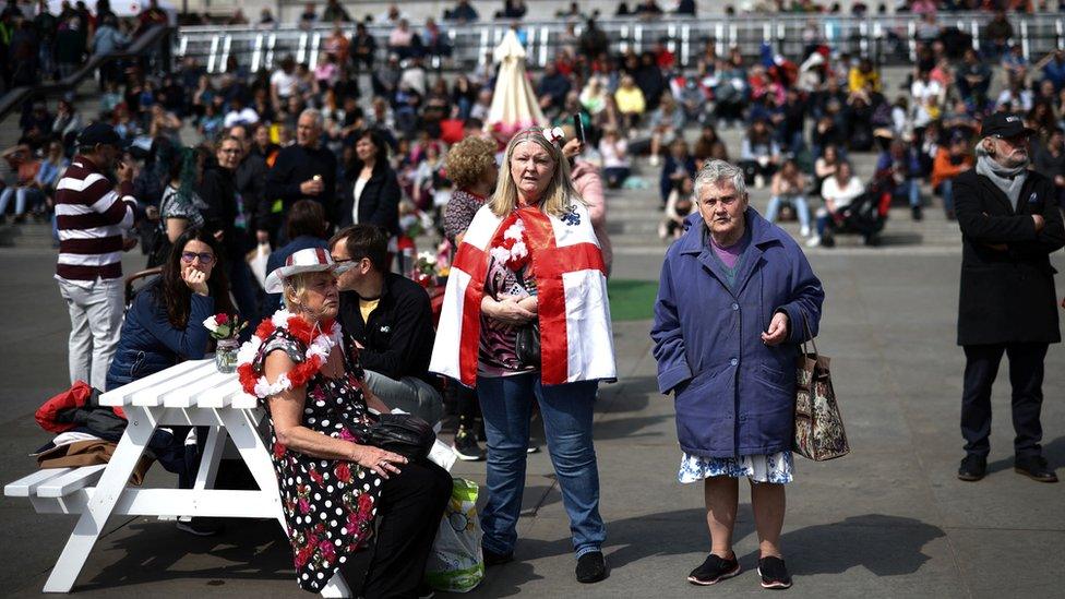 People wearing accessories in the colours of the England flag attend St George"s Day