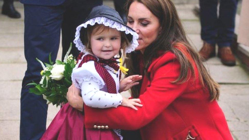 The Princess of Wales receives a posy of flowers from Charlotte Bunting, aged two, as she leaves after a visit to St Thomas Church, in Swansea, Wales. Picture date: Tuesday September 27, 2022.