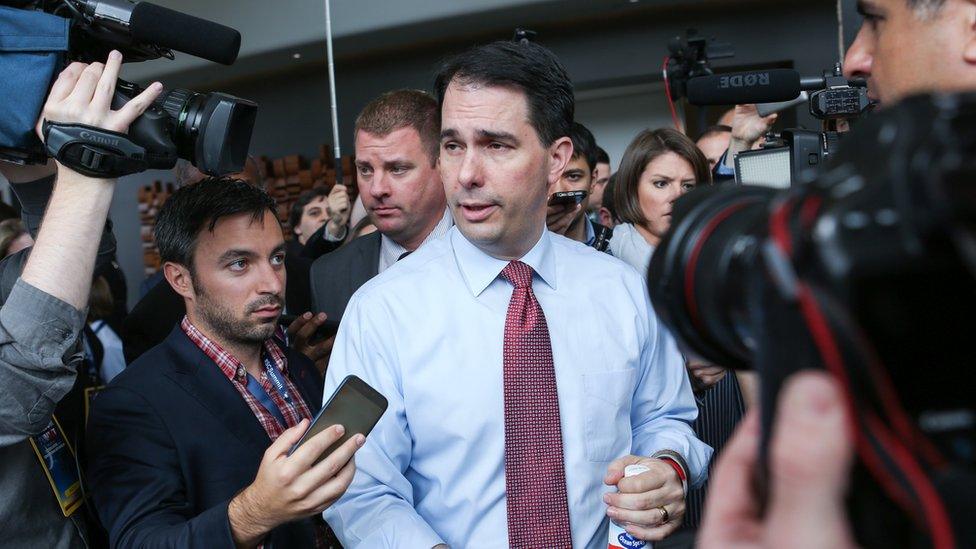 Former Republican presidential candidate Scott Walker speaks to reporters.