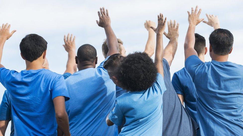 Volunteers raising their hands