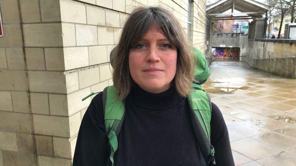 Bethany Mogie outside court with a large camping style rucksack on her back