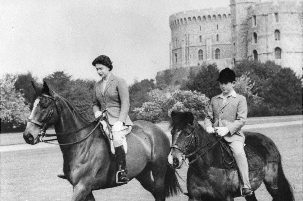 File photo dated 18/05/61 of Queen Elizabeth II and the Prince of Wales, out riding at Windsor Castle