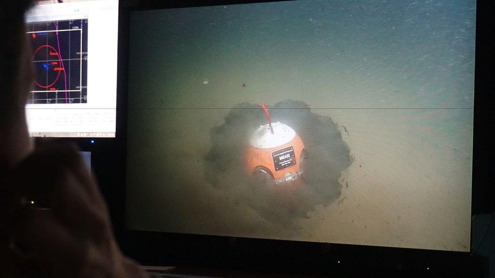 A submersible feeds images back to the surface of a "smart boulder" on the seafloor