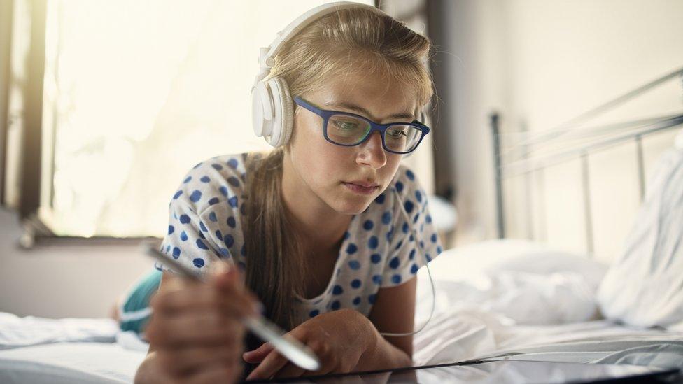 Young girl wearing headphones