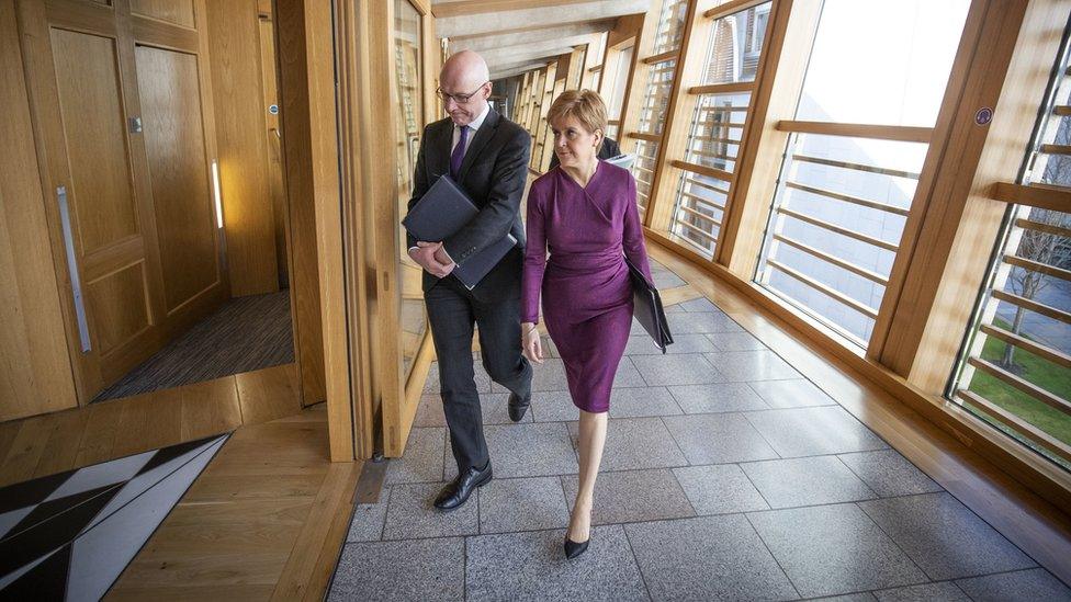 Scottish First Minister Nicola Sturgeon and Deputy First Minister John Swinney arrive ahead of First Minister's Questions (FMQ's) in the debating chamber of the Scottish Parliament on March 19, 2020 in Edinburgh