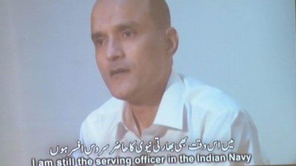 ) In this photograph taken on March 29, 2016, Pakistani journalists watch a video showing Indian national Kulbhushan Yadav, arrested on suspicion of spying, during a press conference in Islamabad