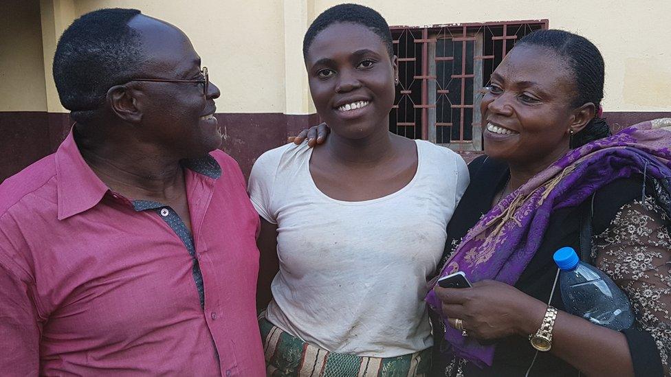 Daughter hugging her parents