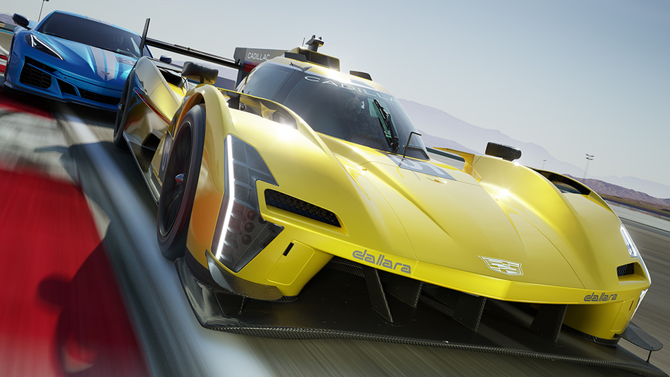 A game screenshot showing a computer-generated yellow sports car closely pursued by a light blue one. The front car has a low, aerodynamic body, with a domed driver's cab in the middle. The car's bodywork is so low that the wheel arches rise visibly above the rest of the with sun reflecting off the metal of the car. The track appears to be based in some sort of desert, and bright, hazy sunshine reflects off the body of the car. The blue car behind is a more traditional, but still very sleek, model. It has a dual white stripe painted along its top