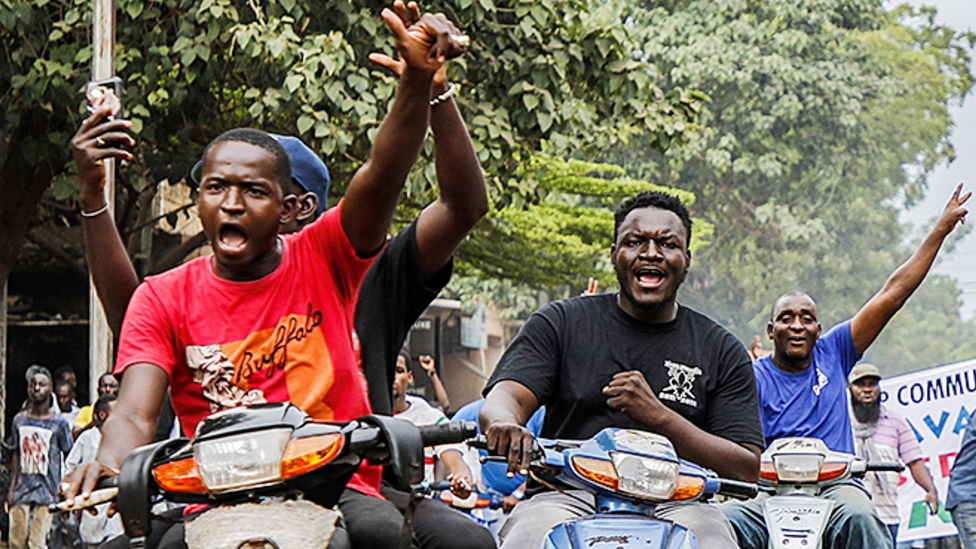 People on motorbikes in Bamako celebrating the military takeover in Mali - August 2020