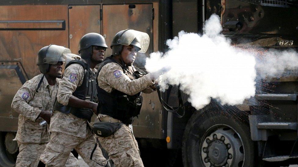 A member of security forces aims a weapon during a protest to demand the resignation of Haitian president Jovenel Moïse, in the streets of Port-au-Prince, Haiti October 11, 2019