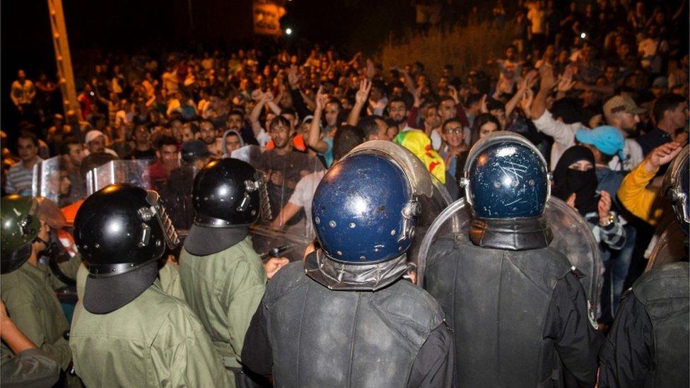 Protesters face security forces during a demonstration