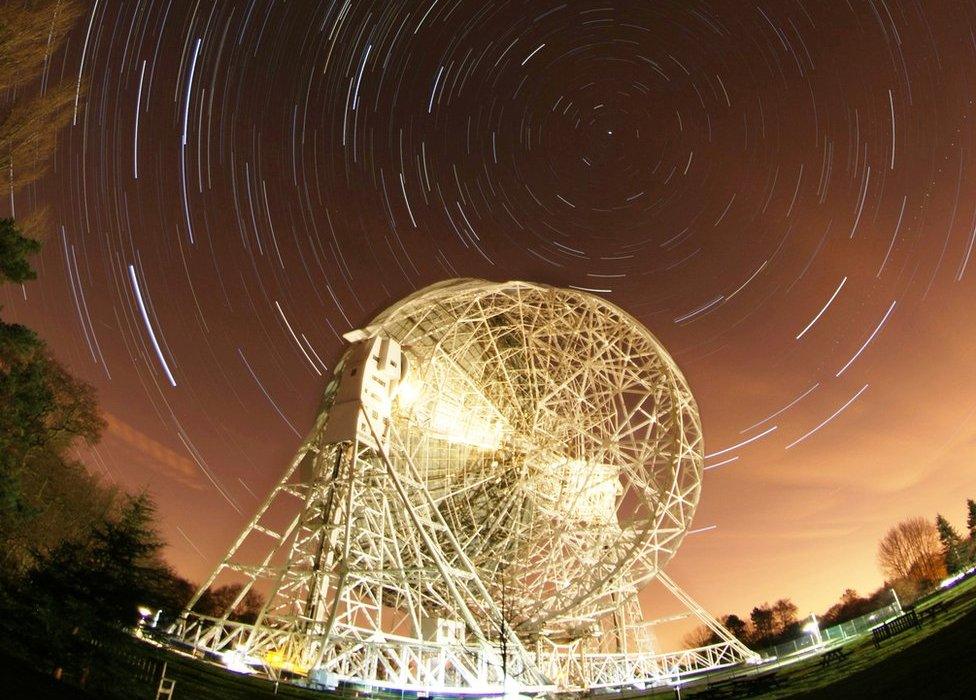 timelapse still of star trails behind the Lovell Telescope