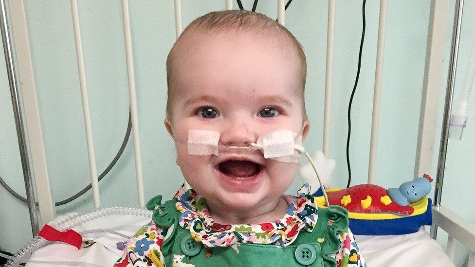 smiling baby Elsie Lark in hospital