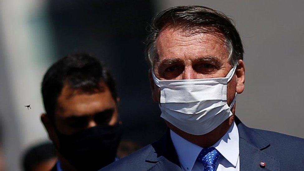 President Jair Bolsonaro walks after a meeting to deliver the interim measure for changes in social welfare program Bolsa Familia (Family Allowance) at the National Congress in Brasilia, Brazil, August 9, 202