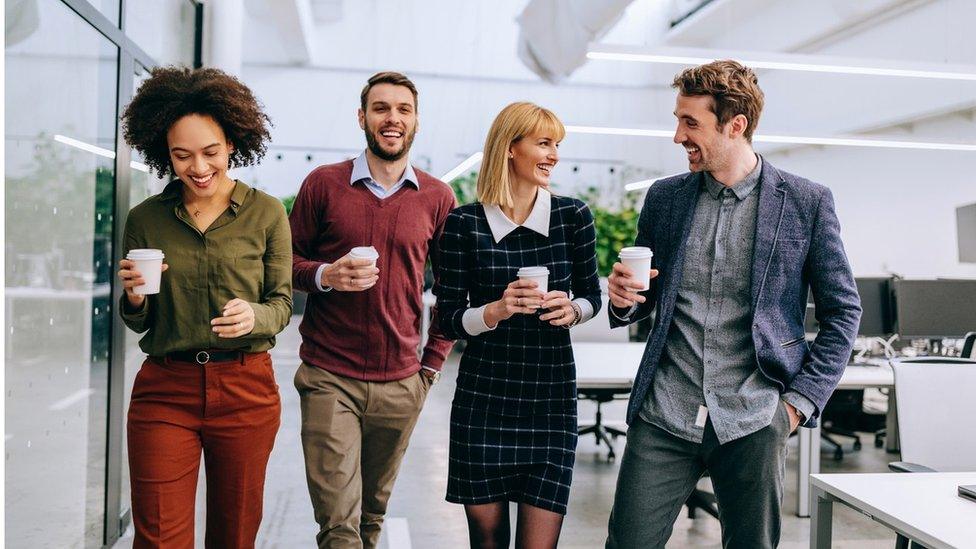 People drinking coffee in an office