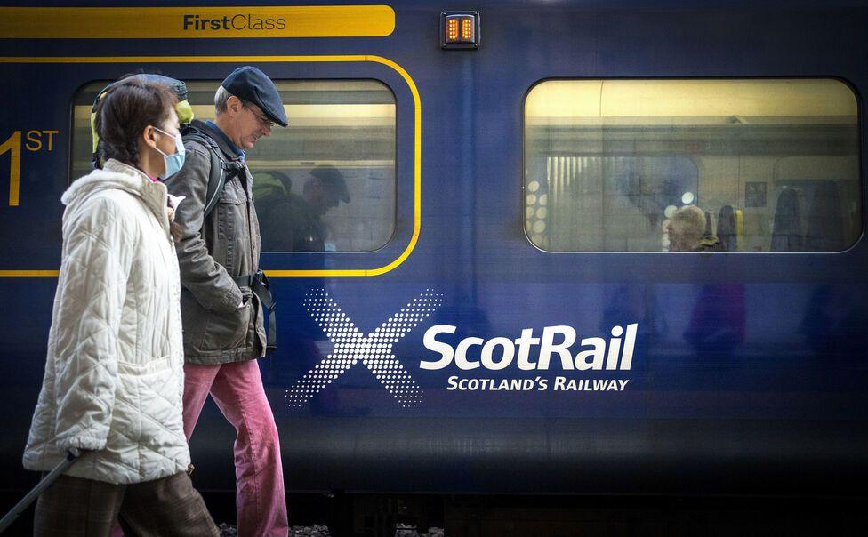 scotrail train passengers beside a train 