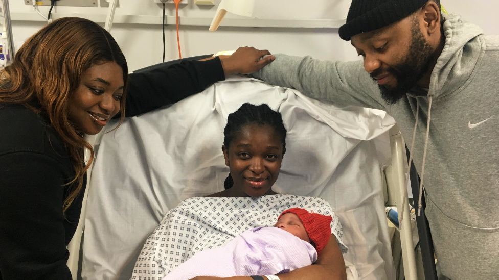 Baby Kairo held by mother Thokozani with father Brian and her sister