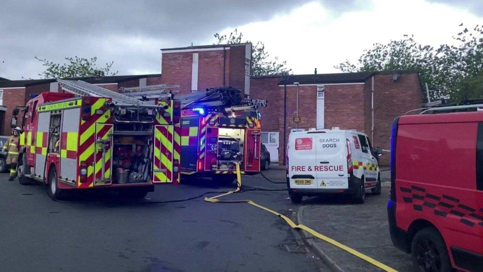 Fire engines and police vehicle at scene of blast