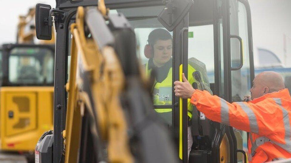 Dominic sitting a digger on a Norfolk roadwork site