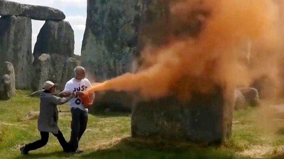 Stonehenge being sprayed with orange powder