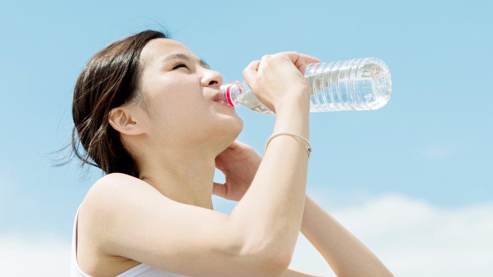 Woman drinking water from a bottle